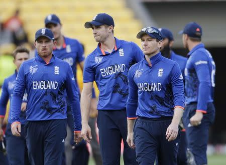 England's captain Eoin Morgan (3nd R) leads his team off the field after Cricket World Cup match loss to Sri Lanka in Wellington, March 1, 2015. REUTERS/Anthony Phelps