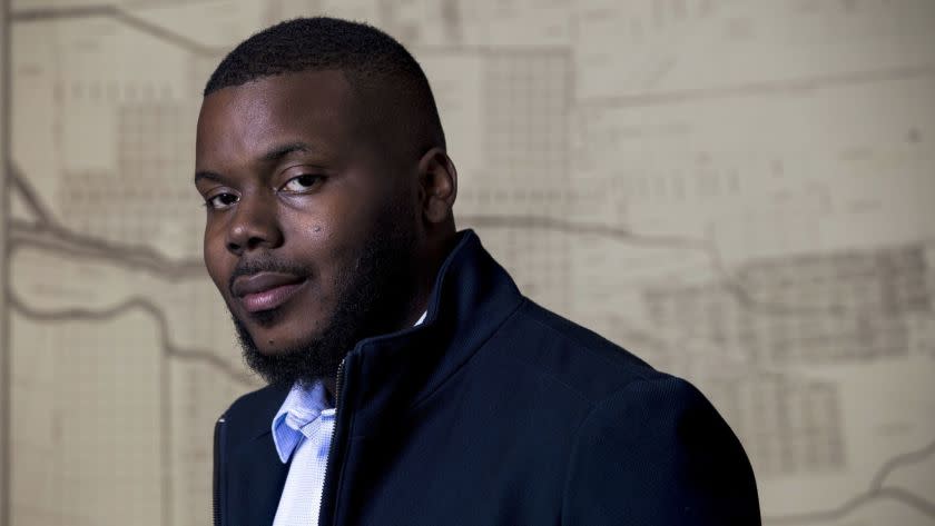 STOCKTON, CA - DECEMBER 19: Mayor Michael Tubbs, 26, poses for a portrait in front of a map of the City of Stockton, in his office at City Hall on December 19, 2017 in Stockton, California. (Kent Nishimura / Los Angeles Times)