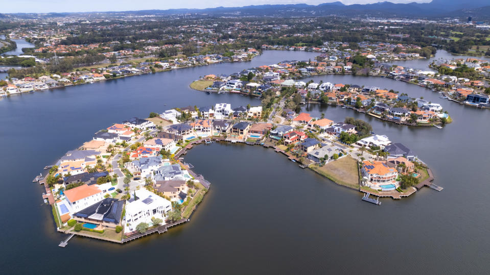 An aerial view of luxury property on canal waterfront.