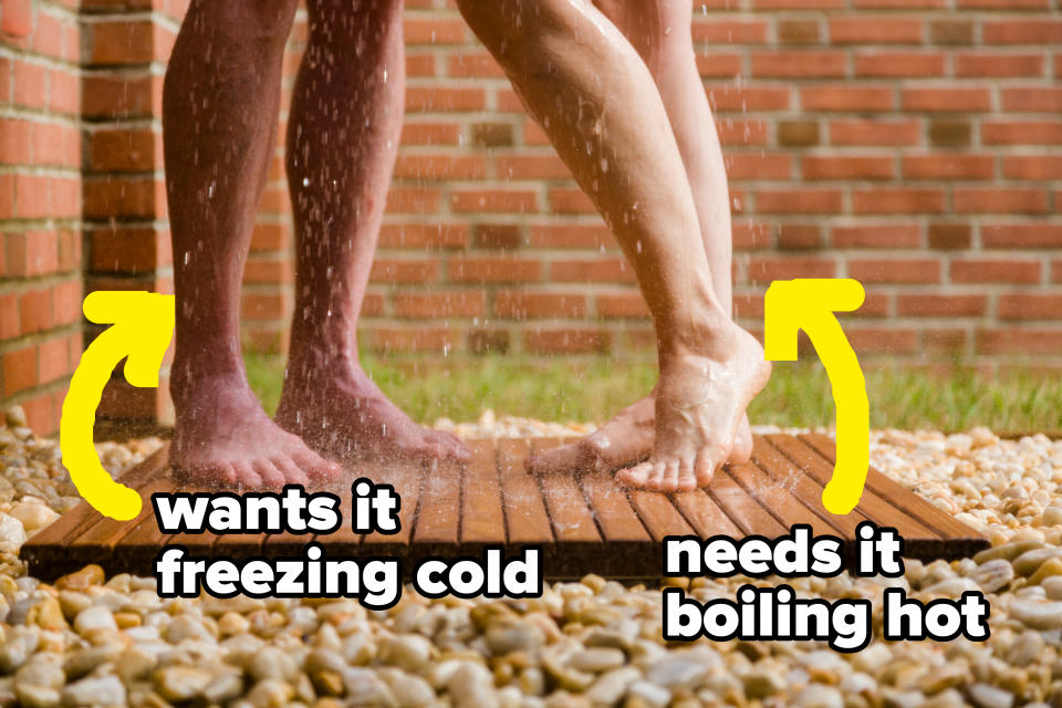 Two pairs of legs stand under a shower; text reads "wants it freezing cold" near one set of feet and "needs it boiling hot" near the other