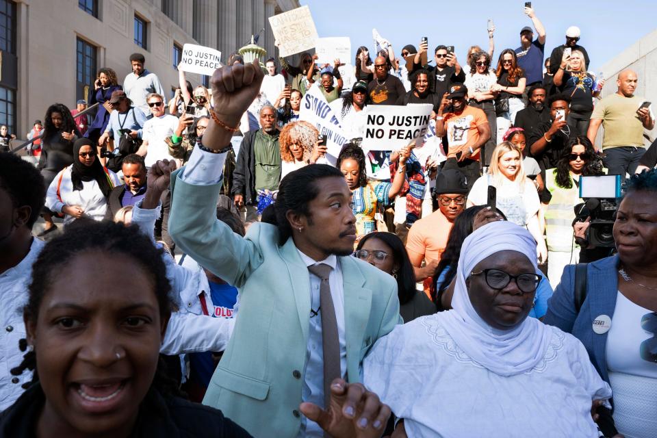 State Rep. Justin Jones, D-Nashville, center, with his fist in the air, marches with supporters to the state Capitol, Monday, April 10, 2023, in Nashville, Tennessee.