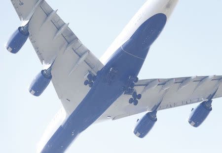 A British Airways 747 with it's undercarriage deployed approaches Heathrow airport over Richmond in west London, June 19, 2015. British police were investigating whether a body found on the roof of a building in southwest London was that of a stowaway who had fallen from the undercarriage of a plane as it came in to land from South Africa. REUTERS/Suzanne Plunkett