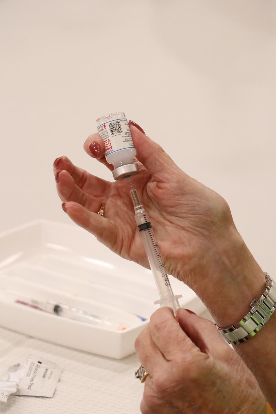 A Moderna vaccine to ward off COVID-19 is prepared at a Sturgis clinic in March.