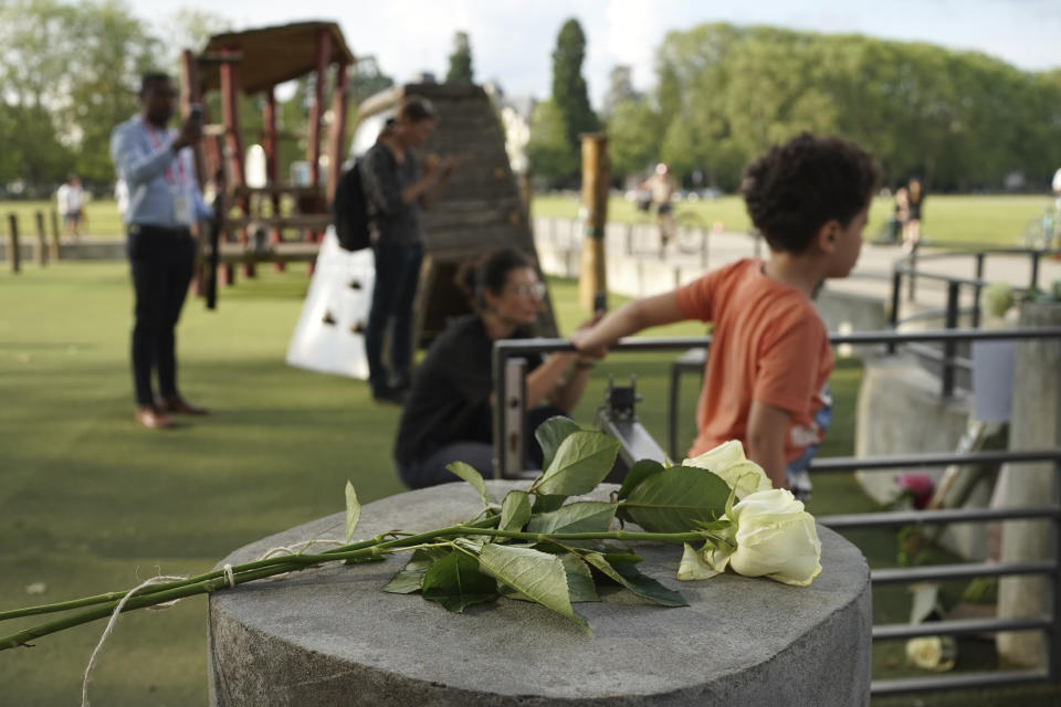 Roses lay at the playground after a knife attack Thursday, June 8, 2023 in Annecy, French Alps. A a man with a knife stabbed four young children at a lakeside park in the French Alps on Thursday, assaulting at least one in a stroller repeatedly. The children between 22 months and 3 years old suffered life-threatening injuries, and two adults also were wounded, authorities said. (AP Photo/Laurent Cipriani)