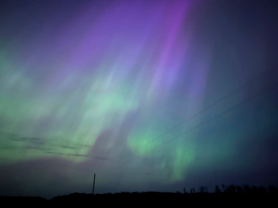 Northern lights glow in the sky near Kroschel, Minn., late Friday, May 10, 2024. (Owen Caputo Sullivan via AP)