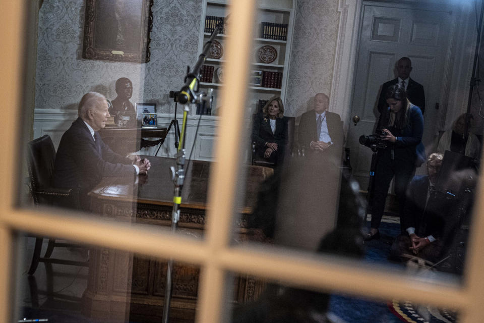 President Joe Biden speaks from the Oval Office of the White House in Washington on Thursday, Oct. 19, 2023, about the conflicts between Israel and Hamas, and Ukraine and Russia. At center is first lady Jill Biden. (AP Photo/Andrew Harnik)