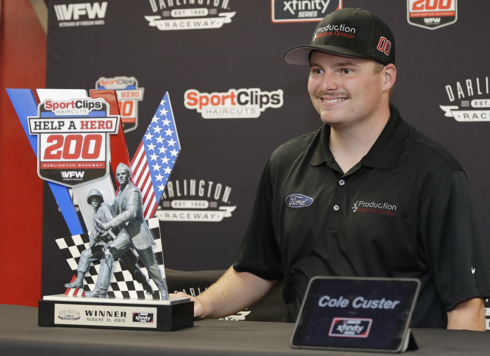 Cole Custer poses with the winner's trophy after Denny Hamlin was disqualified for failing a post-race inspection at the NASCAR Xfinity Series auto race on Saturday, Aug. 31, 2019, at Darlington Raceway in Darlington, S.C. (AP Photo/Terry Renna)