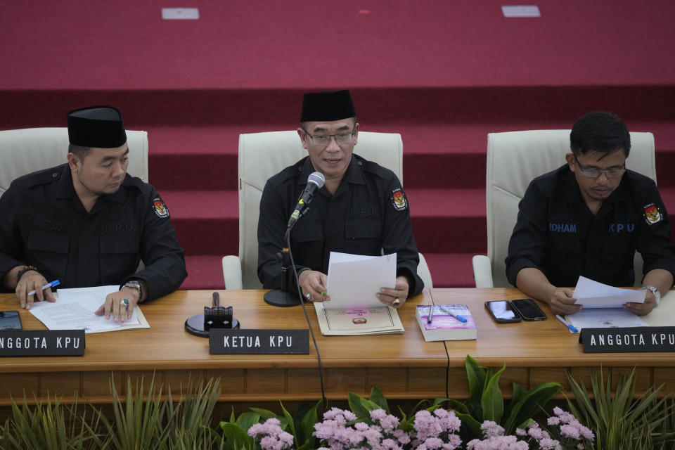 Chairman of the General Election Commission, Hasyim Asyari, center, is flanked by members Mochammad Afifuddin, left, and Idham Holik as he reads a document certifying the results of Feb. 14 presidential and legislative elections during a plenary meeting at the commission's office in Jakarta, Indonesia, Wednesday, March 20, 2024. Prabowo Subianto, a former special forces general with ties to Indonesia's current president and past dictatorship, was confirmed the victor of last month's presidential election over two former governors who have vowed to contest the result in court. (AP Photo/Dita Alangkara)