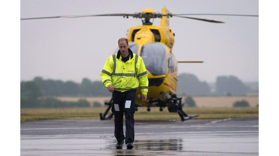 Prince William walking away from an air ambulance