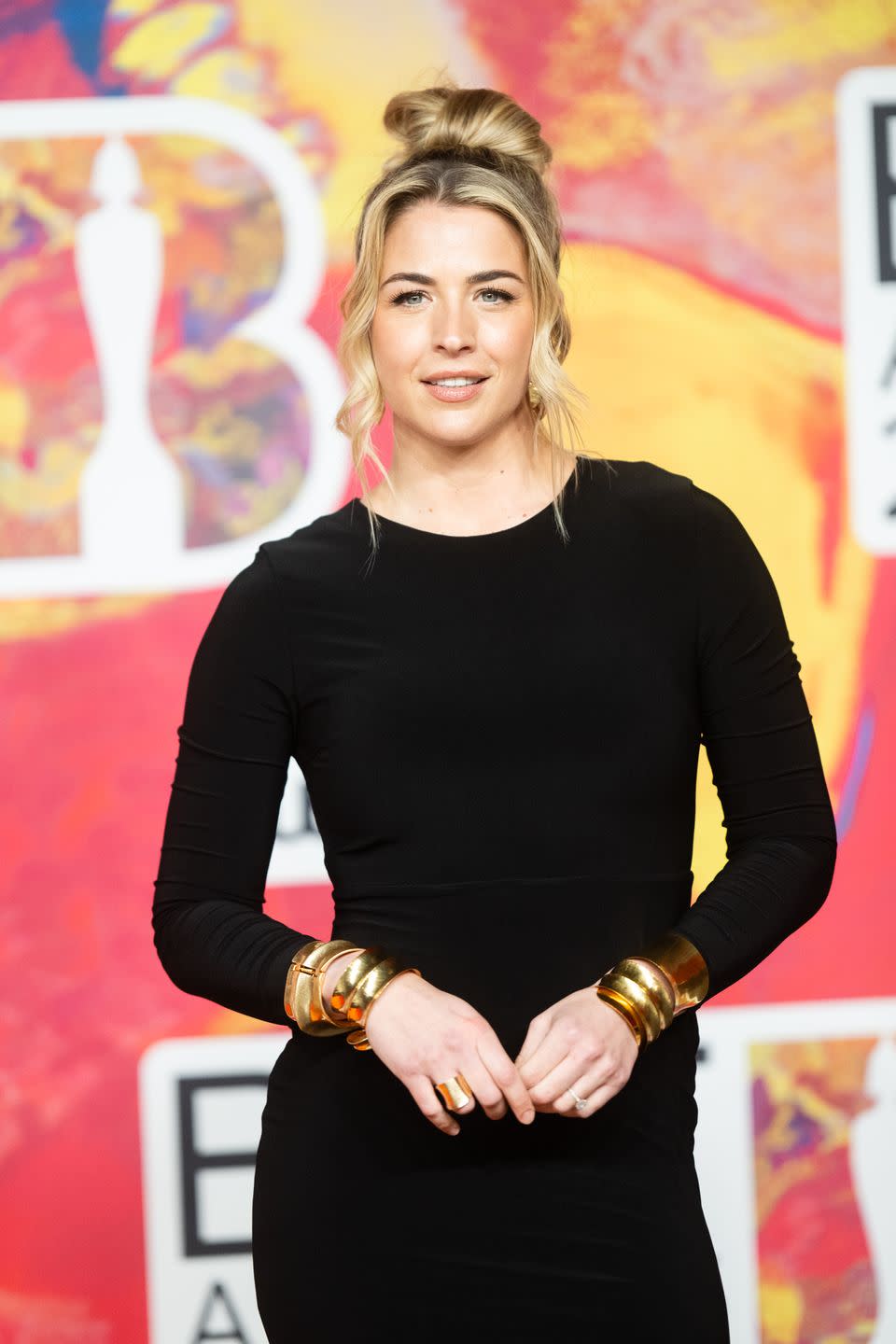 gemma atkinson wearing a black long sleeve dress and her hair in an up do