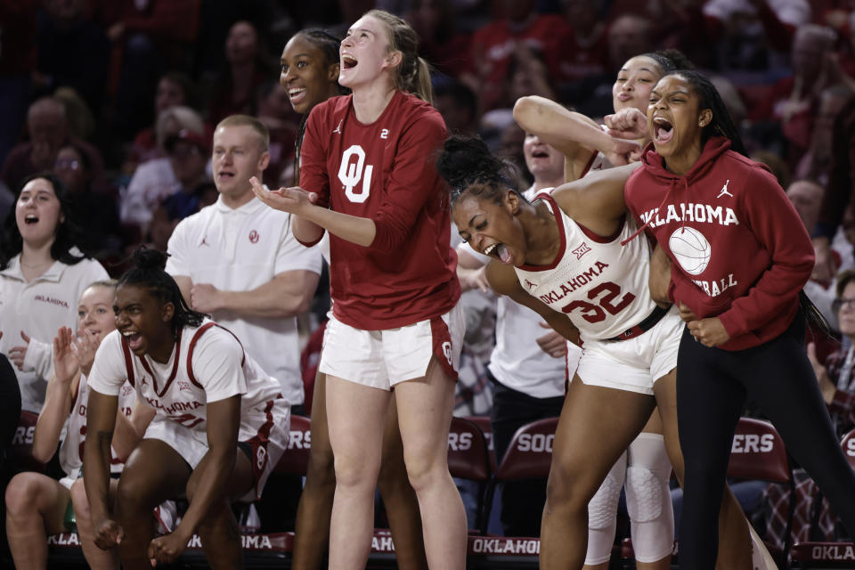 Oklahoma players react from the sideline during the first half of an NCAA college basketball game against Texas Wednesday, Feb. 28, 2024, in Norman, Okla. (AP Photo/Garett Fisbeck)