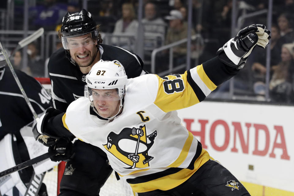 Pittsburgh Penguins' Sidney Crosby, bottom, works against Los Angeles Kings' Kurtis MacDermid during the third period of an NHL hockey game Wednesday, Feb. 26, 2020, in Los Angeles. (AP Photo/Marcio Jose Sanchez)