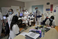 Medical staff have a team meeting at the emergency ward of the Rouvray psychiatric hospital, in Rouen, western France, Wednesday, Nov. 25, 2020. Lockdowns that France has used to fight the coronavirus have come at considerable cost to mental health. Surveying points to a surge of depression most acute among people without work, in financial hardship and young adults. (AP Photo/Thibault Camus)