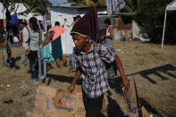 A Honduran migrant arrives at a temporary shelter in Tecun Uman, Guatemala in the border with Mexico, Sunday, Jan. 19, 2020. Mexican authorities have closed a border entry point in southern Mexico after thousands of Central American migrants tried to push across a bridge between Mexico and Guatemala. (AP Photo/Moises Castillo)