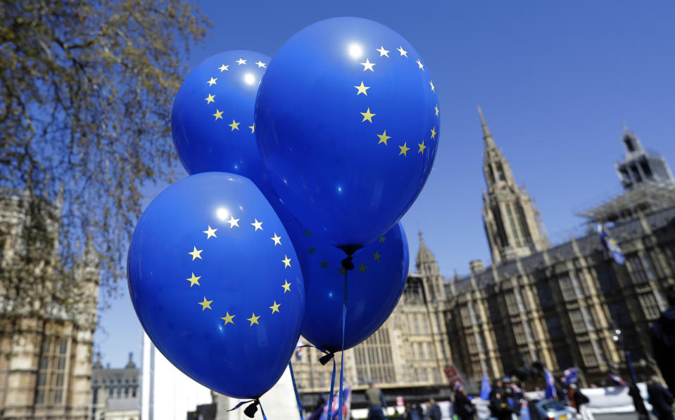 Balloons bearing the star emblem of the European Union flag fly near Parliament in London, Wednesday, April 10, 2019.   Just days away from a no-deal Brexit, European Union leaders meet Wednesday to discuss granting the United Kingdom a new delay to its departure from the bloc.(AP Photo/Kirsty Wigglesworth)