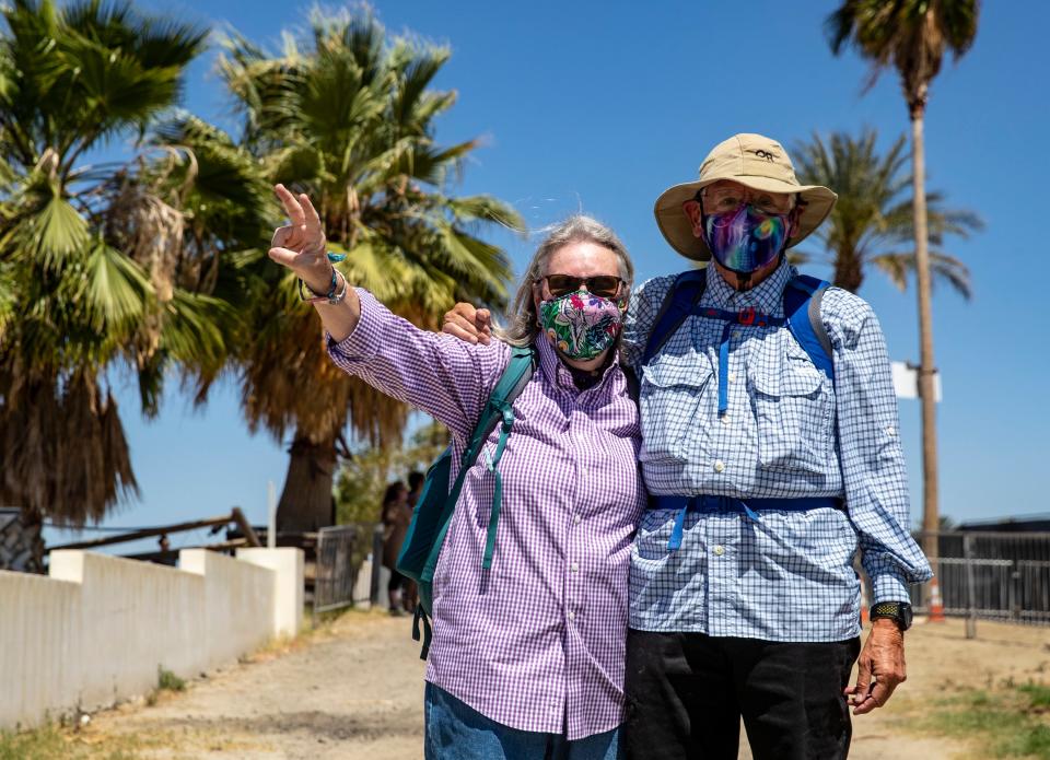 Sally and Bob Arroyo of La Quinta, 73 and 80-years-old respectively, pose for a photo while walking in to the Coachella Valley Music and Arts Festival in Indio, Calif., Friday, April 12, 2024. The couple says this is nearly their tenth year attending the festival and that they go to both weekends and even have attended Stagecoach some years.
