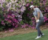 Dustin Johnson chips to the 13th green during the first round for the Masters golf tournament Thursday, April 11, 2019, in Augusta, Ga. (AP Photo/David J. Phillip)