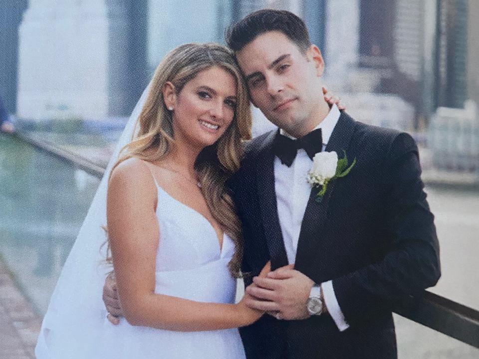 A photo of a couple on their wedding day in front of the Manhattan skyline.