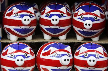 Piggy banks adorned with the colours of Britain's Union Jack flag are displayed in a souvenir shop in London in this March 24, 2010 file photo. REUTERS/Darrin Zammit Lupi/Files