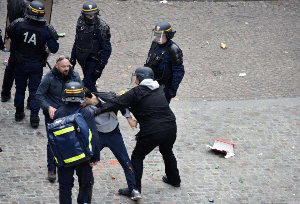 This image appears to show Alexandre Benalla (centre) wearing a police visor, next to Vincent Crase (AFP/Getty Images)