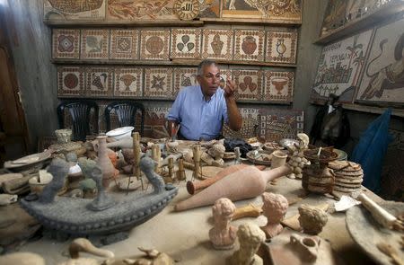 Archeology Nafez Abed sits in front of sculptures and intricate mosaics at his workroom, at Shati refugee camp in Gaza City, November 8, 2015. REUTERS/Suhaib Salem