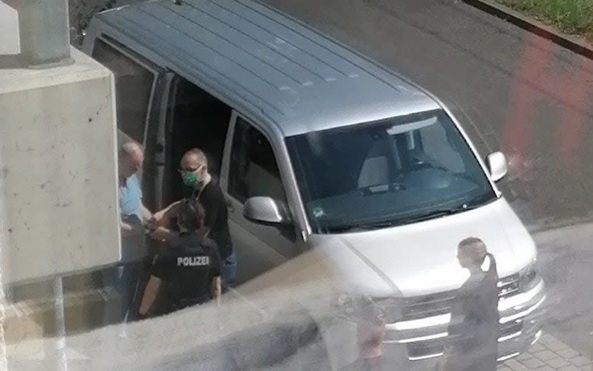 British national David Smith being handcuffed and led into an unmarked van by police on Tuesday afternoon - Henry Bodkin