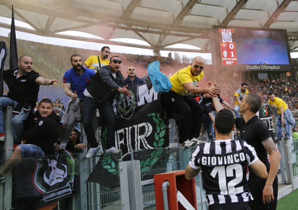 Juventus players Leonardo Bonucci, right, and Sebastian Giovinco celebrate with supporter at the end of an Italian Serie A soccer match between Roma and Juventus at Rome's Olympic stadium, Sunday, May 11, 2014. Juventus won 1 - 0. (AP Photo/Alessandra Tarantino)