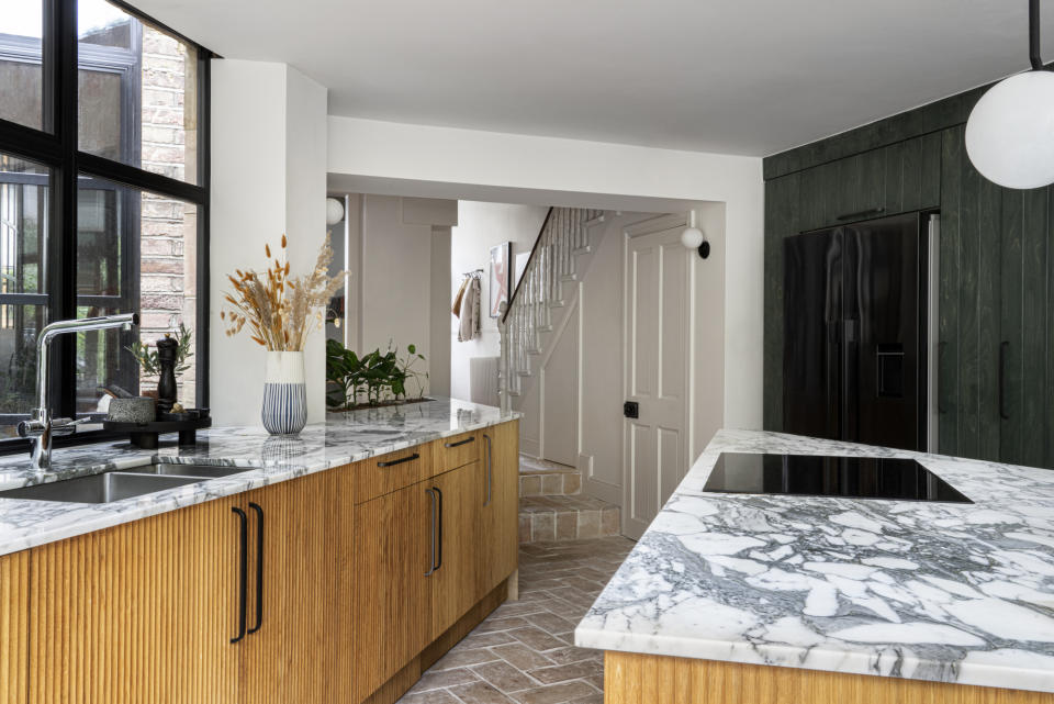 Angular kitchen cabinets lead to the living room