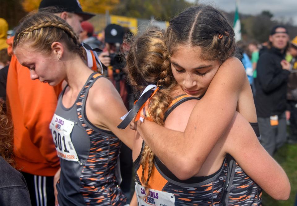 In this file photo from last fall, Washington freshman Sophia Ramirez, facing, shares a hug with sophomore Olivia Nordhielm after their Class 2A state girls cross-country race at Detweiller Park in Peoria.