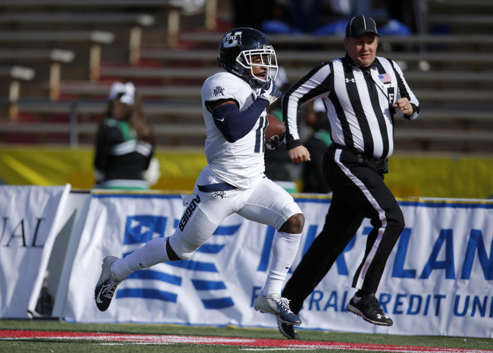 Utah State wide receiver Aaren Vaughns sprints to the end zone to score a touchdown against North Texas during the first half of the New Mexico Bowl NCAA college football game in Albuquerque, N.M., Saturday, Dec. 15, 2018. (AP Photo/Andres Leighton)