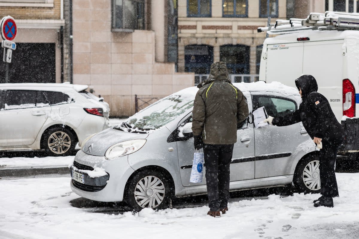 Removing ice and snow is a sign of winter (AFP via Getty Images)