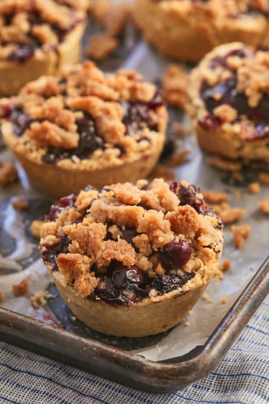 <p>Bigger Bolder Baking</p><p>These blueberry crumb pies have a juicy blueberry filling, delicious pie crust bottom, and an irresistible cinnamon crumb topping.</p><p><strong>Get the recipe: <a href="https://www.biggerbolderbaking.com/individual-blueberry-crumb-pies/" rel="nofollow noopener" target="_blank" data-ylk="slk:Mini Blueberry Crumb Pies;elm:context_link;itc:0;sec:content-canvas" class="link rapid-noclick-resp">Mini Blueberry Crumb Pies</a></strong></p>