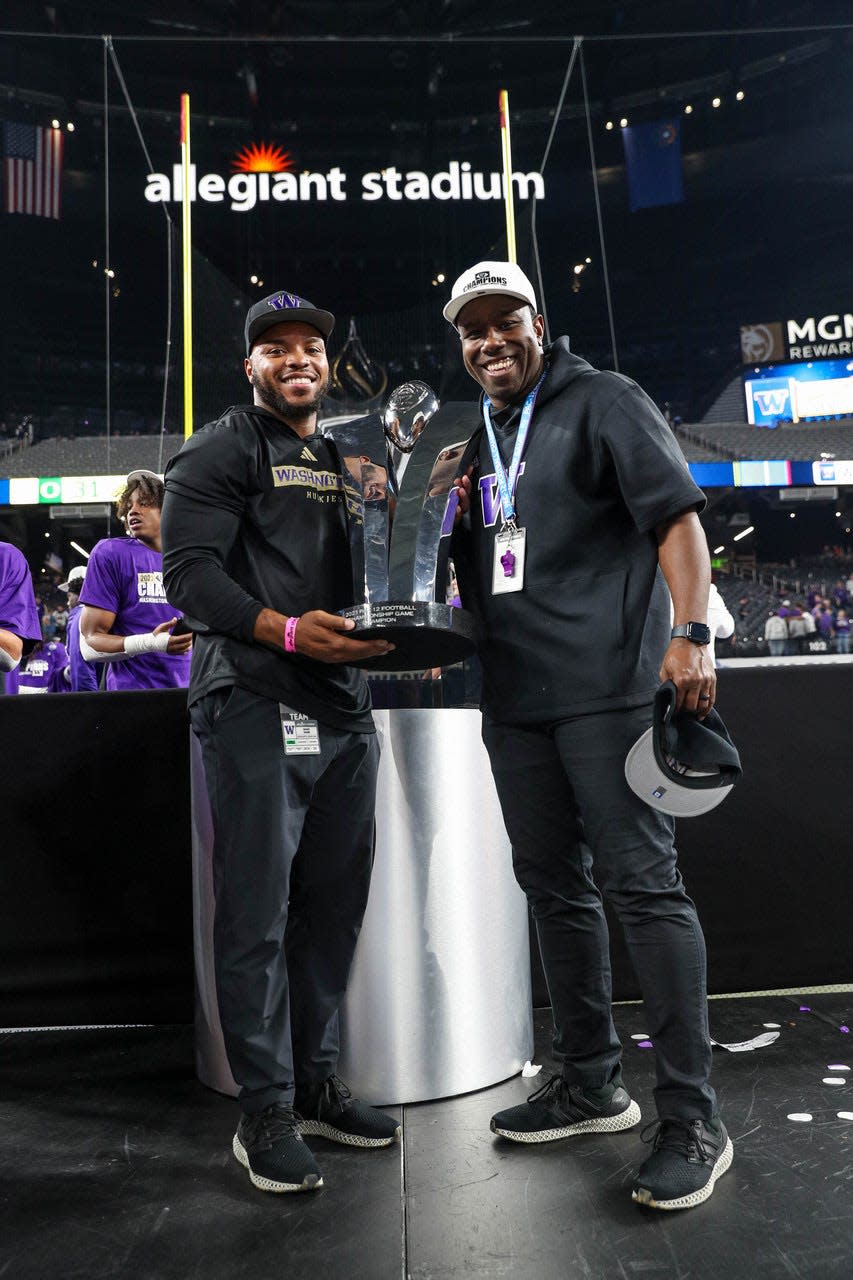 South Bend Adams alum and Washington football assistant coach Shaq Vann, left, takes a photo with Huskies receiver coach JaMarcus Shephard following the Pac-12 Championship game Friday, Dec. 1, 2023, in Las Vegas.