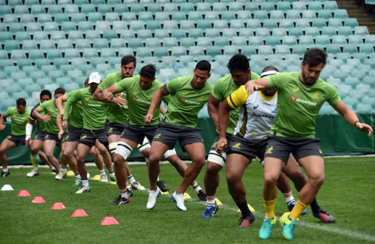 Australian Wallabies' players perform warm-up exercises during a training session in Sydney on August 23, 2016, ahead of their Bledisloe Cup second round match against New Zealand