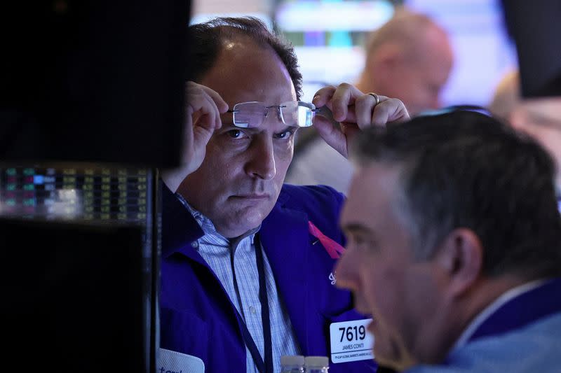 Traders work on the floor of the NYSE in New York