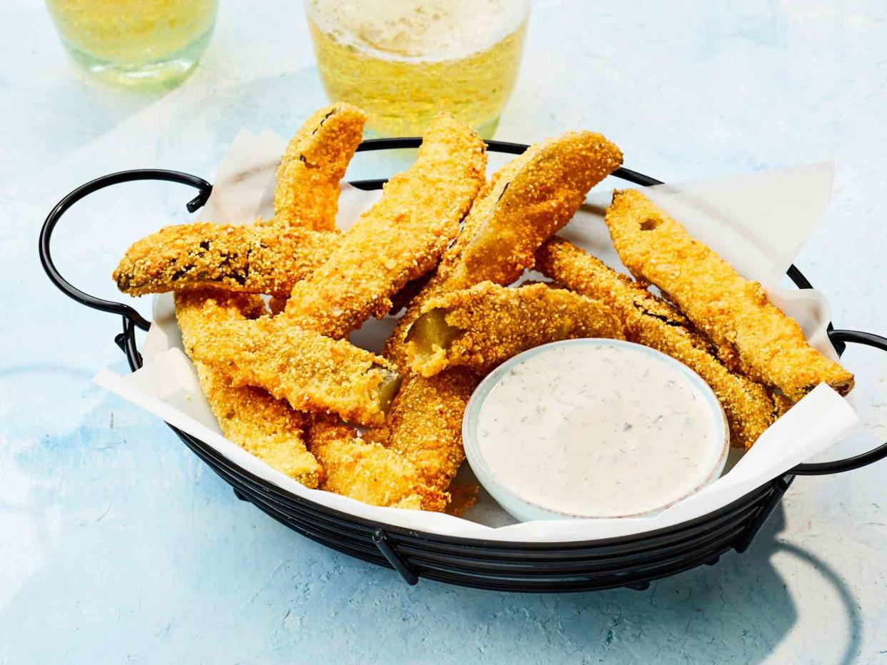 crispy fried pickles in a basket with ranch dipping sauce