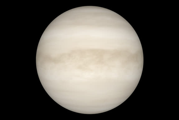 A view of Venus with visible light reveals a smooth, white sphere. The light cannot penetrate the planet's thick cloud layer.