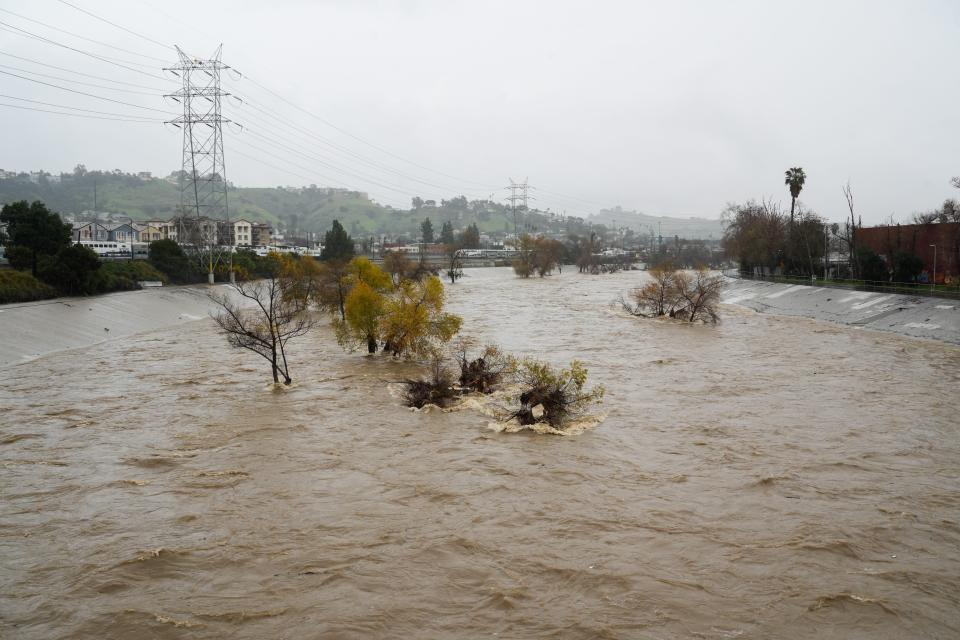 The Los Angeles River soars above normal levels as it carries stormwater toward the Pacific Ocean on Feb. 5, 2024.