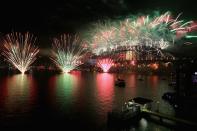 SYDNEY, AUSTRALIA - DECEMBER 31: Fireworks light up the sky above the Sydney Harbour Bridge at midnight during New Years Eve celebrations on Sydney Harbour on December 31, 2012 in Sydney, Australia. (Photo by Cameron Spencer/Getty Images)