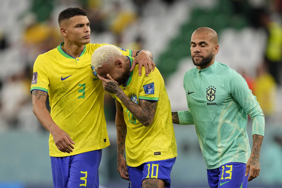 Brazil's Neymar reacts after the penalty shootout besides Brazil's goalkeeper Ederson and Brazil's Thiago Silva at the World Cup quarterfinal soccer match between Croatia and Brazil, at the Education City Stadium in Al Rayyan, Qatar, Friday, Dec. 9, 2022. (AP Photo/Martin Meissner)