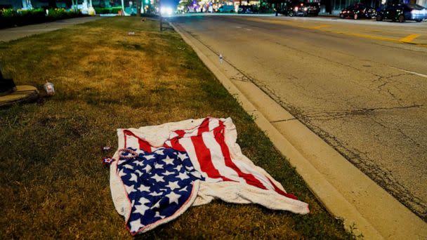 PHOTO: An American flag blanket is seen abandoned along the parade route after a mass shooting at a Fourth of July parade in the Chicago suburb of Highland Park, Illinois, on July 4, 2022. (Cheney Orr/Reuters)