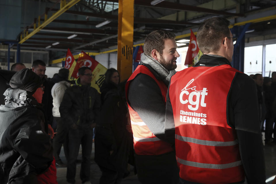 Railway workers gather during a meeting of the CGT union in Rennes, western France, Monday, Dec. 9, 2019. Unions launched nationwide strikes and protests over the government's plan to overhaul the retirement system. Paris commuters inched to work Monday through exceptional traffic jams, as strikes to preserve retirement rights halted trains and subways for a fifth straight day. (AP Photo/David Vincent)