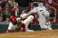 St. Louis Cardinals' Lars Nootbaar, left, is tagged out by Colorado Rockies third baseman Ryan McMahon after Nootbaar overran third base during the eighth inning of a baseball game Wednesday, Aug. 17, 2022, in St. Louis. (AP Photo/Jeff Roberson)