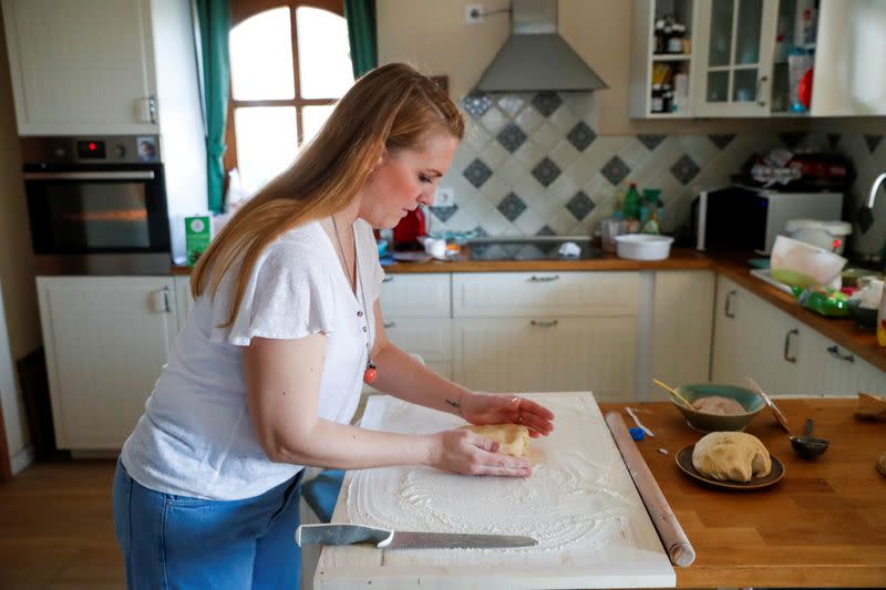 Eszter Harmath prepares dough before baking a cake at her home, during COVID-19 pandemic, in Szentendre