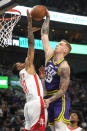 Houston Rockets forward Jabari Smith Jr. defends against Utah Jazz forward Luka Samanic during the first half of an NBA basketball game, Thursday, April 11, 2024, in Salt Lake City. (AP Photo/Rick Bowmer)