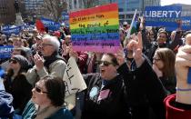 Demonstrators gather at Monument Circle to protest a controversial religious freedom bill recently signed by Governor Mike Pence during a rally in Indianapolis March 28, 2015. More than 2,000 people gathered at the Indiana State Capital Saturday to protest Indiana's newly signed Religious Freedom Restoration Act saying it would promote discrimination against individuals based on sexual orientation. (REUTERS/Nate Chute)