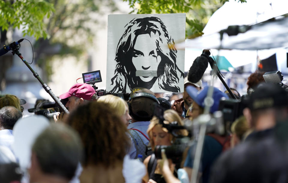 A portrait of Britney Spears looms over supporters and media members outside a court hearing concerning the pop singer's conservatorship at the Stanley Mosk Courthouse, Wednesday, June 23, 2021, in Los Angeles. (AP Photo/Chris Pizzello)