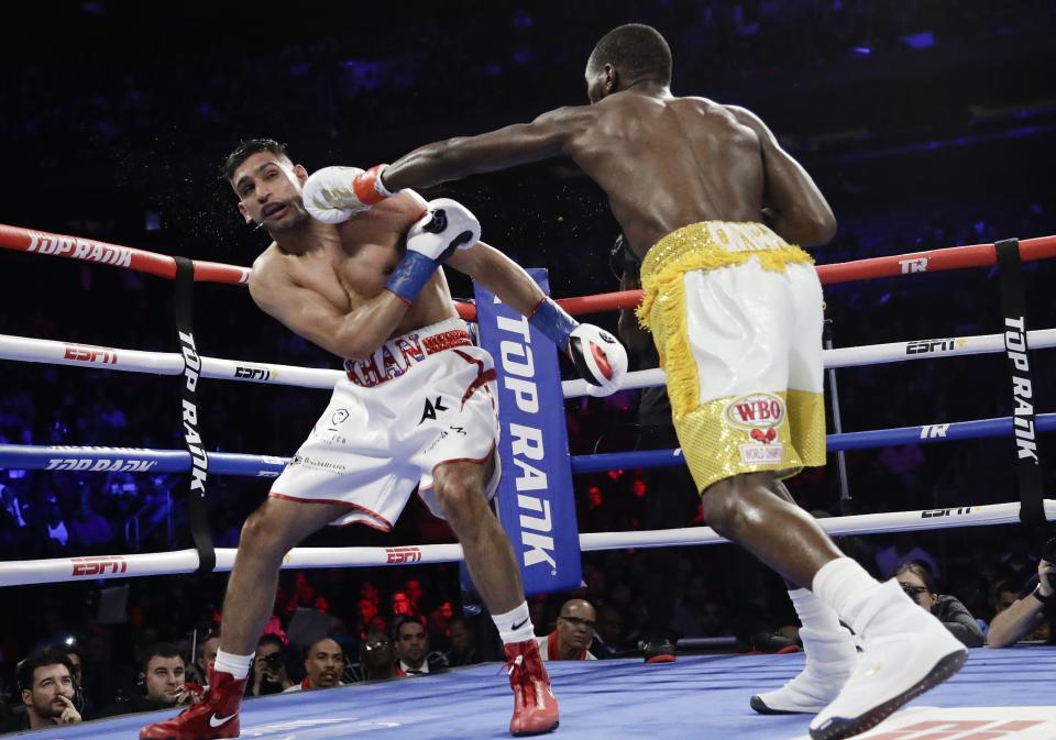 Terence Crawford, right, punches England's Amir Khan during the fifth round of a WBO world welterweight championship boxing match Sunday, April 21, 2019, in New York. Crawford won the fight. (AP Photo/Frank Franklin II)