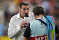 South Africa's coach Rassie Erasmus takes a drink as his players warm up ahead of the Rugby World Cup Pool B game at the City of Toyota Stadium between South Africa and Namibia in Toyota City, Japan, Saturday, Sept. 28, 2019. (AP Photo/Christophe Ena)