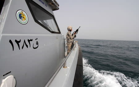 A Saudi border guard watches as he stands in a boat off the coast of the Red Sea on Saudi Arabia's maritime border with Yemen, near Jizan, April 8, 2015.REUTERS/Faisal Al Nasser